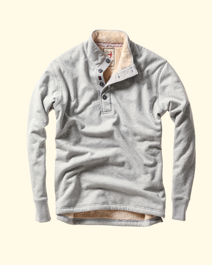 Gray fleece pullover with sherpa lining on a beige background