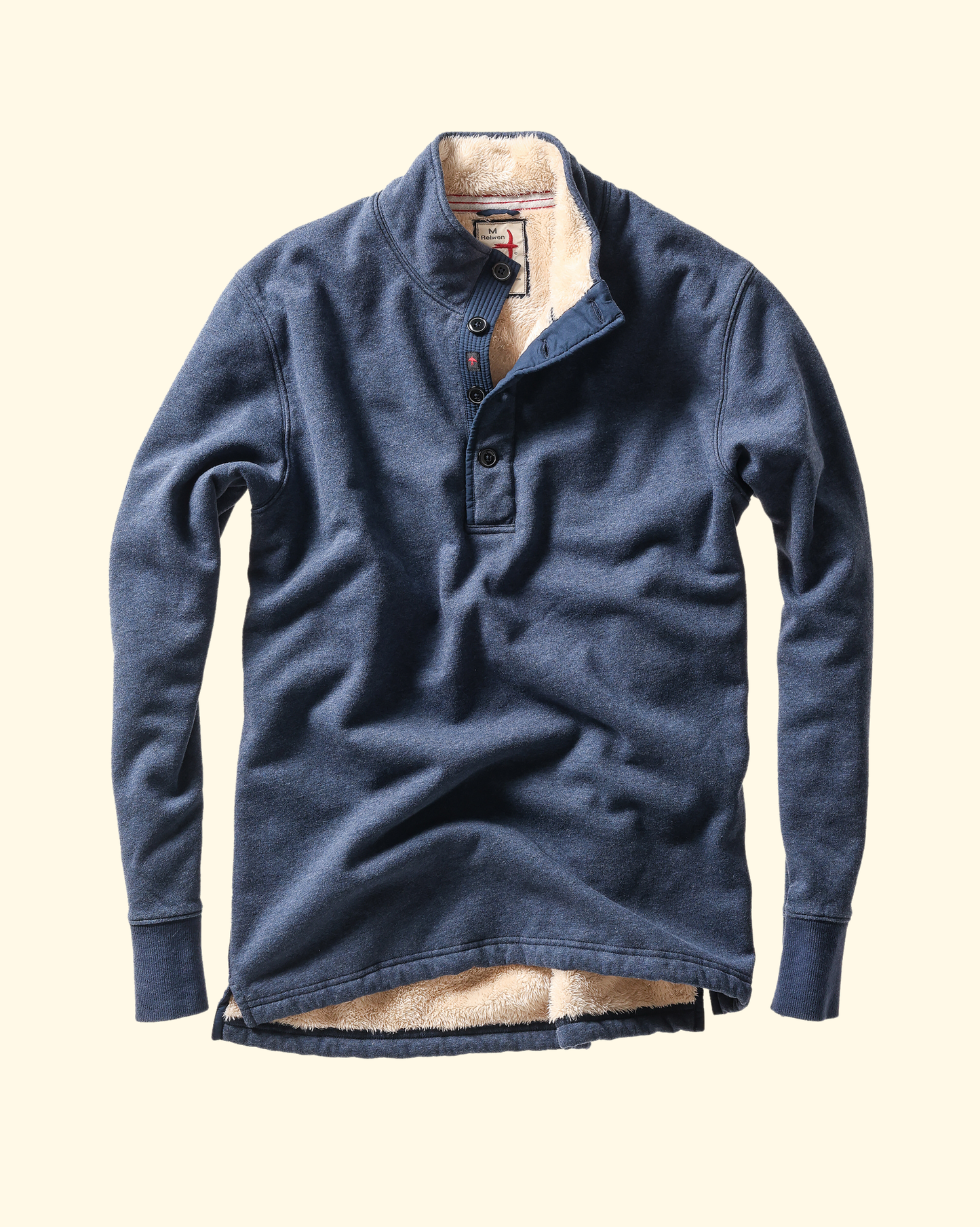 Blue long-sleeve shirt with beige shearling  interior on a beige background