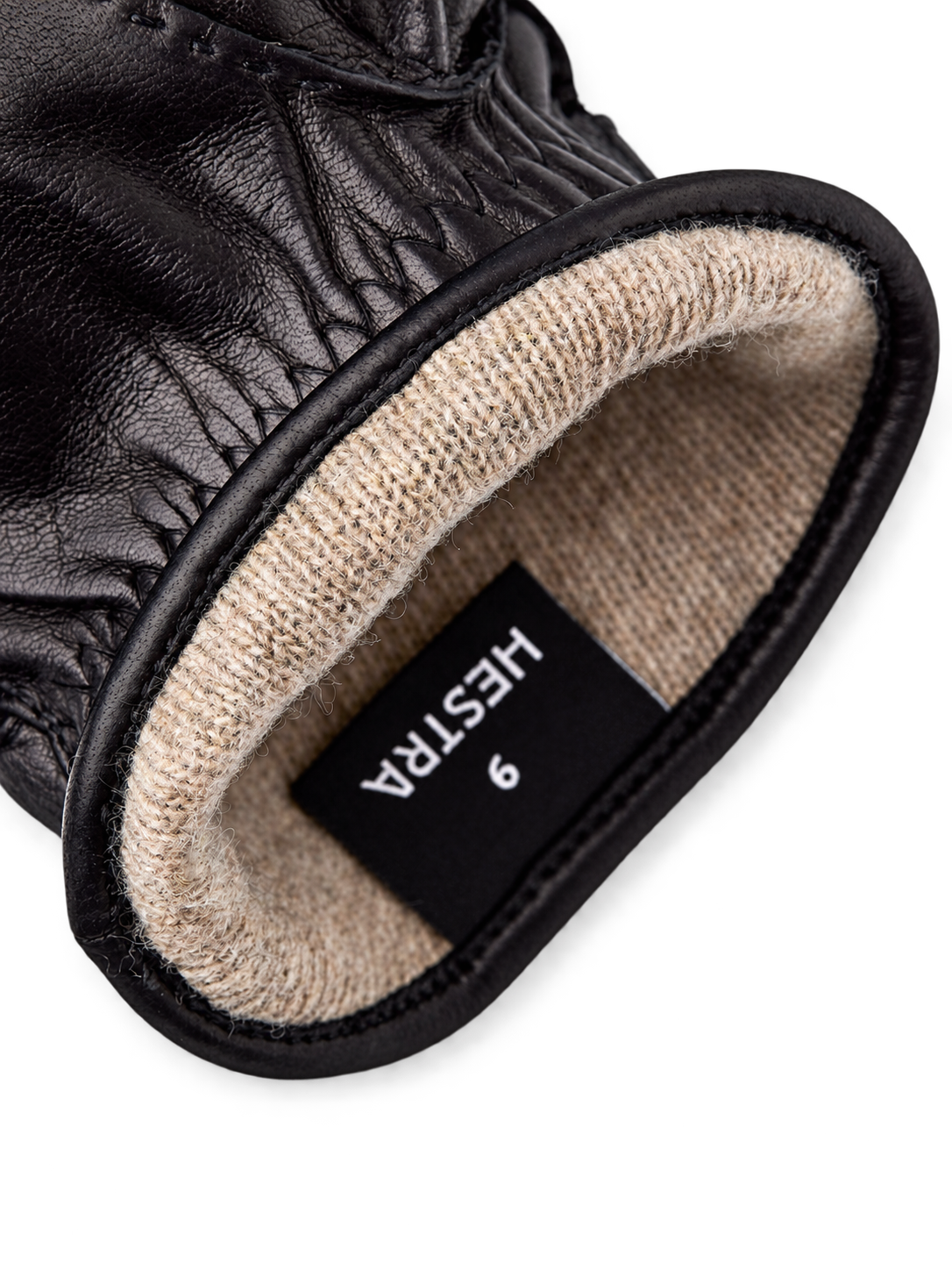 Hestra Jake black lining detail, AI-edited background